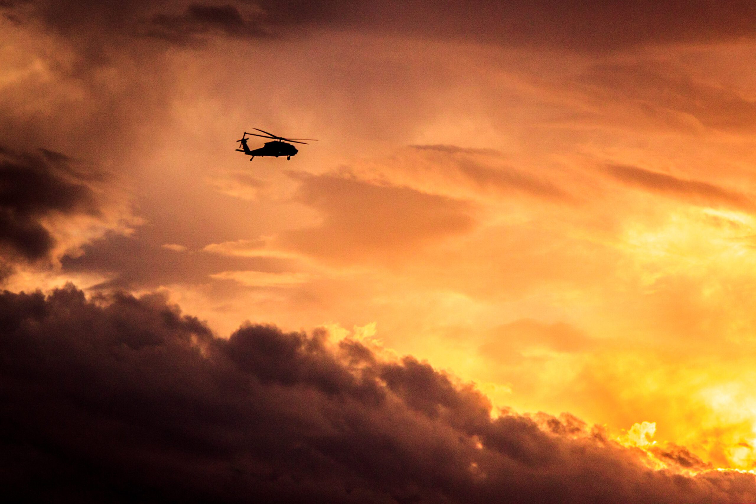 Helicopter flying at sunset