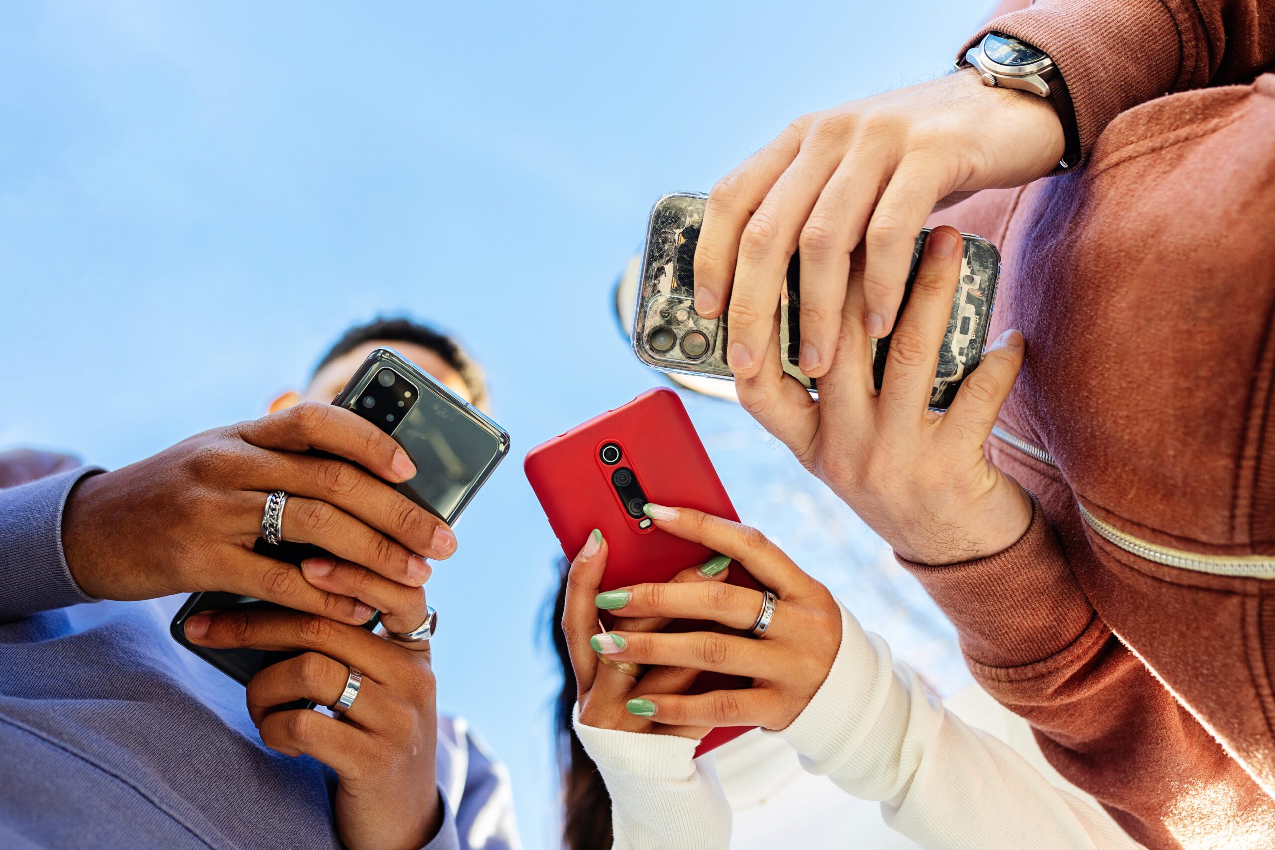 A group of people looking at their mobile phones