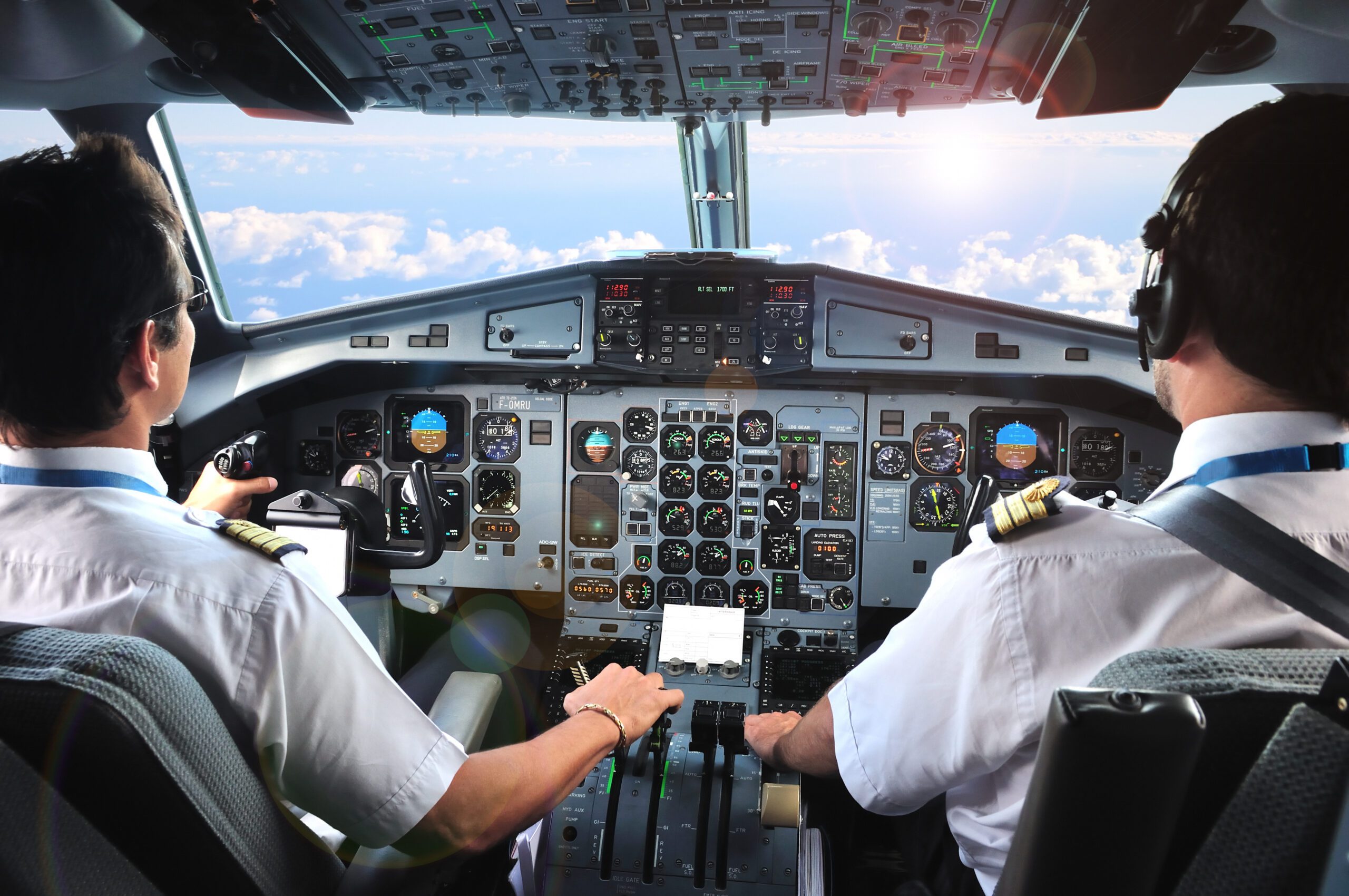 Two pilots in the cockpit of an airplane.